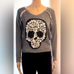 I.Ner grey pullover sweater w/embroidered skull graphic w/white floral details.